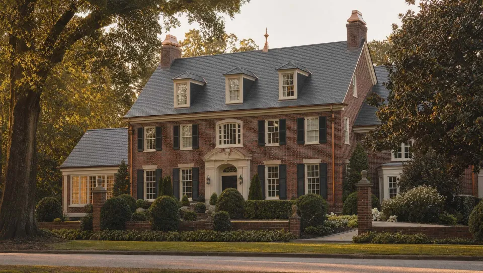 Ridgeline studio showpiece with a slate roof, brick elevation, and copper details.